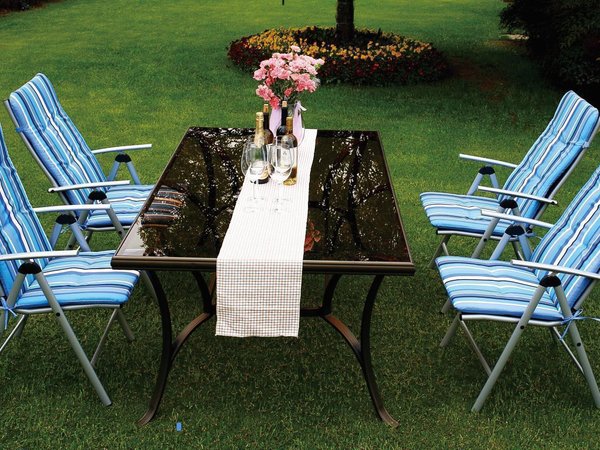 Blue and white striped cushions on metal folding chairs in garden setting