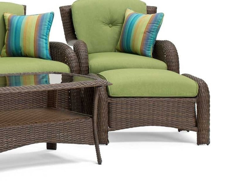 Striped accent pillows in blue, teal, yellow and orange on wicker armchair