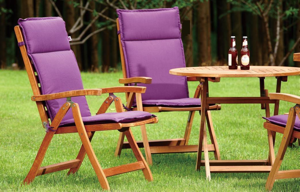 Bright pink cushioned outdoor chair on a green lawn