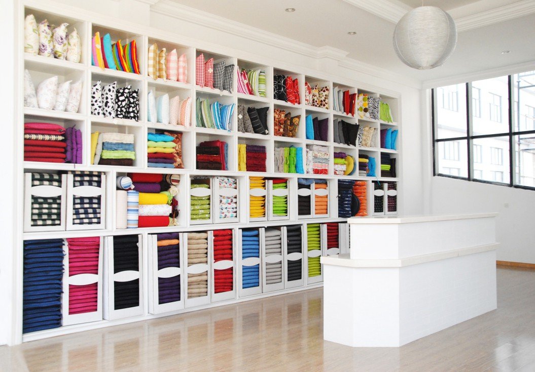 Wall of fabric color swatches and samples in the BETTER-LIVING fabric library